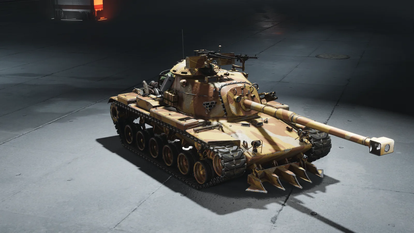 A tank with a tall, rounded turret in a sandy tan desert camouflage, lit from above on a plain studio floor.