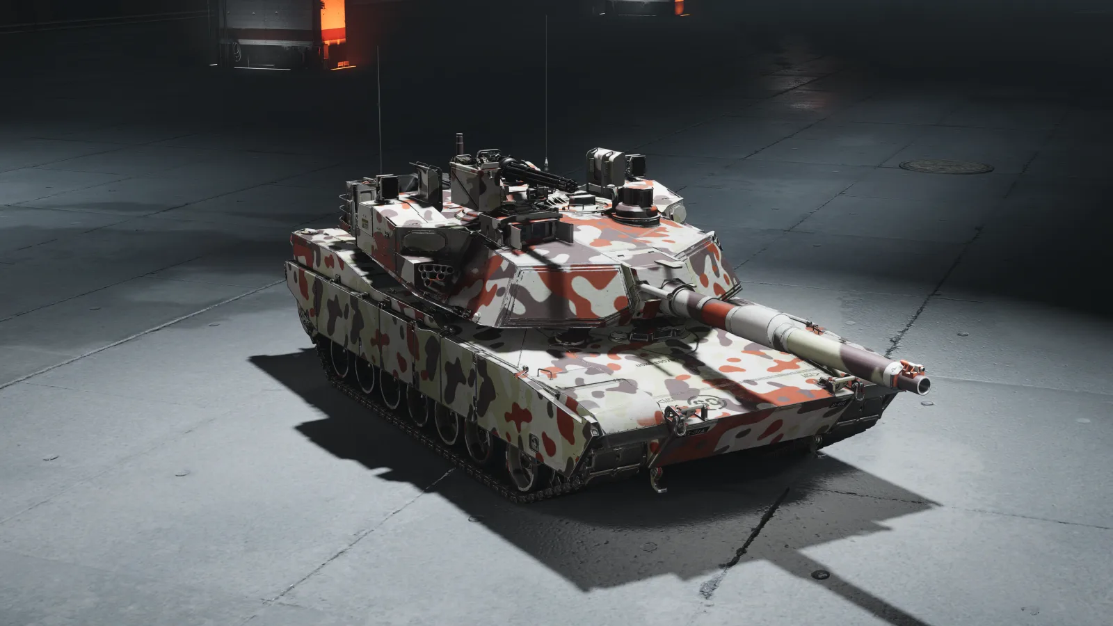 A tank in a splinter camouflage pattern of red, olive green, and white, lit from above on a plain studio floor.