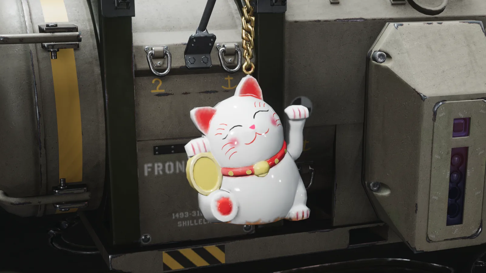 A charm shaped like a cat figure with one paw raised in a waving pose, hanging by a chain from the side of a vehicle.